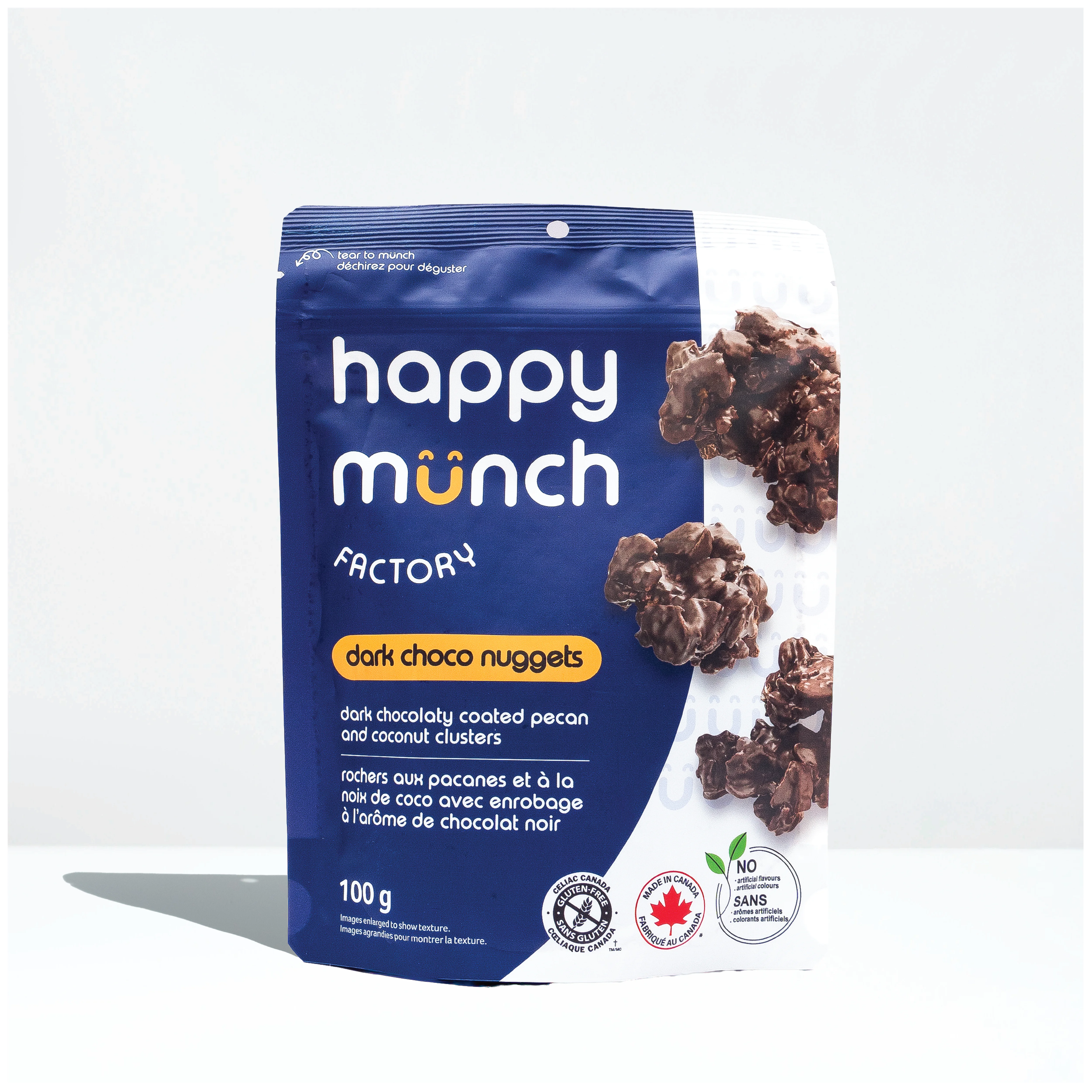 Front of Happy Munch Dark Choco Nuggets Chocolaty coated pecan and coconut clusters on a white background