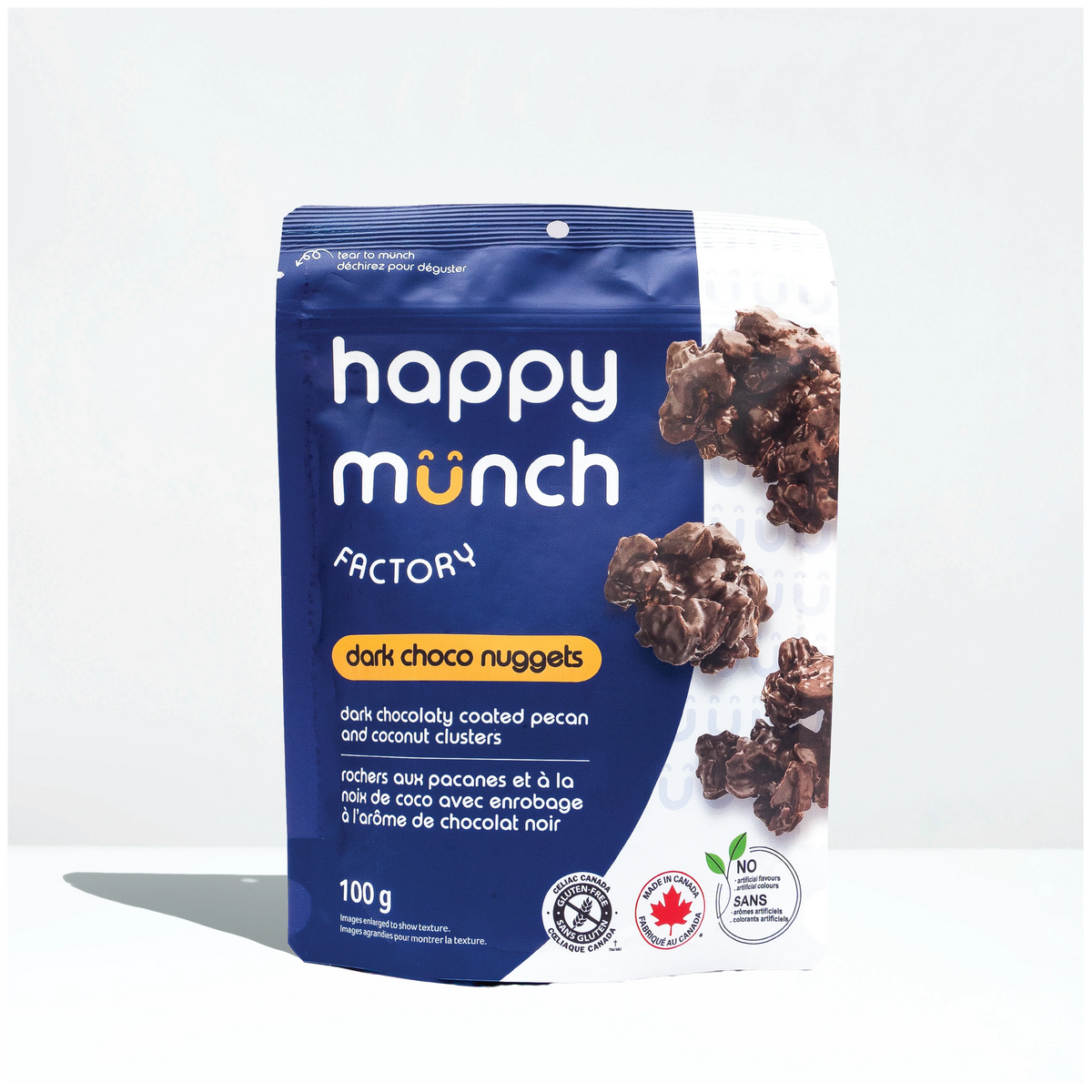 Front of Happy Munch Dark Choco Nuggets Chocolaty coated pecan and coconut clusters on a white background