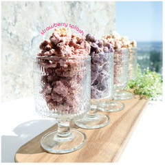 Happy Munch Yogurt Clusters in Decorative glass containers with Strawberry Splash in the foreground.