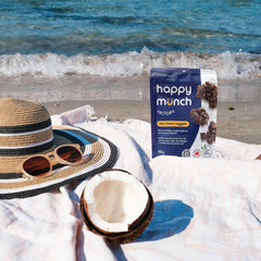happy munch dark choco nuggets pouch on a beach with a hat and coconut